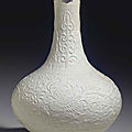 A white-glazed relief-decorated soft-paste bottle vase, 18th century
