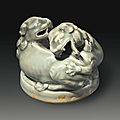 A yaozhou celadon censer cover in the form of two entwined lions, china, northern song-jin dynasty, 12th-13th century