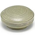 An incised Yue celadon 'floral' box and cover, Five Dynasties (907-960)