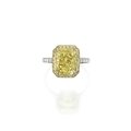 Platinum, 18 karat gold, fancy intense yellow diamond, colored diamond and diamond ring