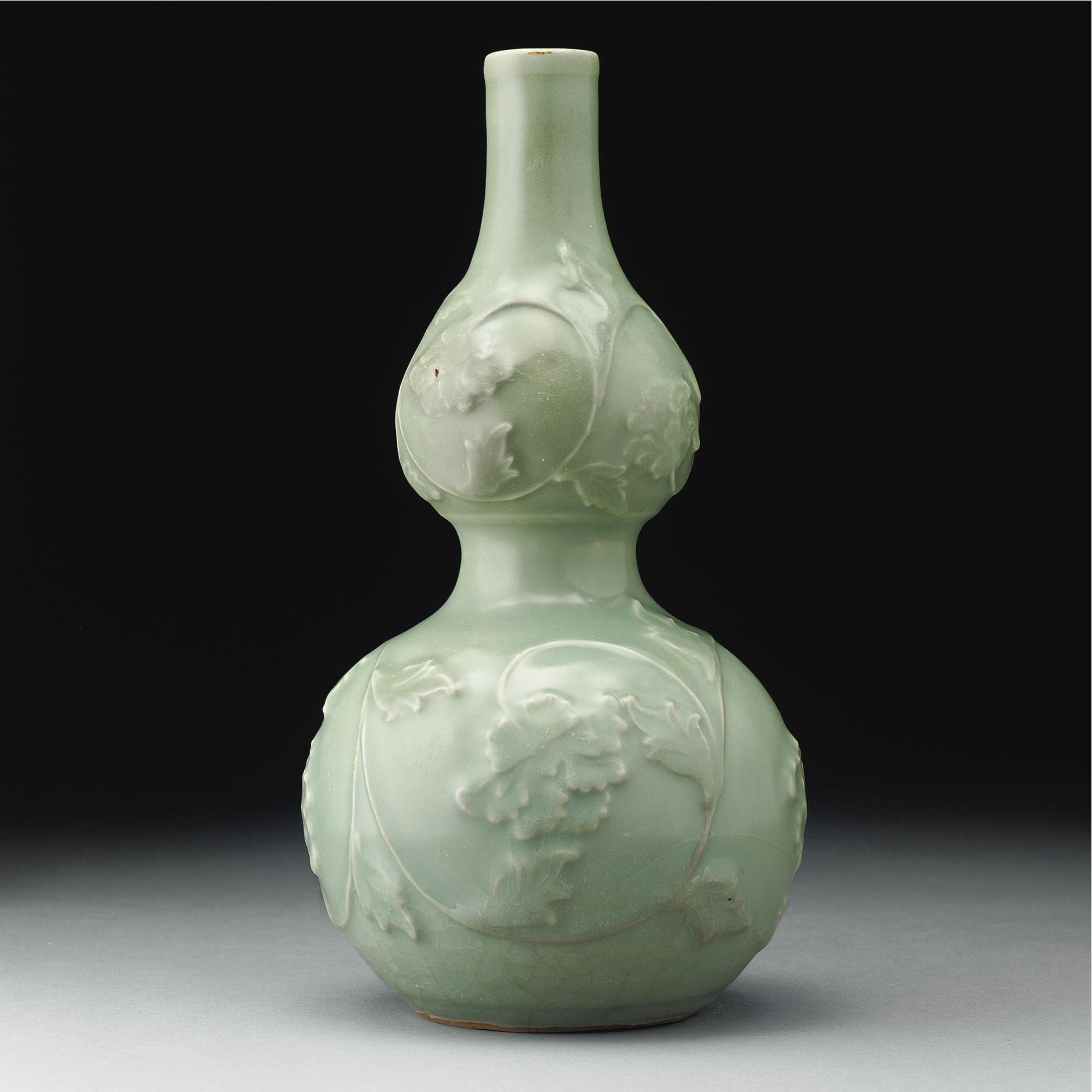 A rare 'longquan' celadon double-gourd vase with applied decoration, Yuan dynasty