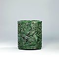 A finely carved and reticulated spinach green jade brush pot, qianlong period (1736-1795)