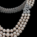 A three-strand natural pearl, cultured pearl and diamond necklace