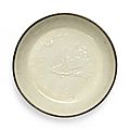 A rare dingyao moulded 'xiniu and moon' dish, jin dynasty (1115-1234)