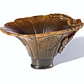 A Carved Rhinoceros Horn 'Dragon and Lotus' Libation Cup