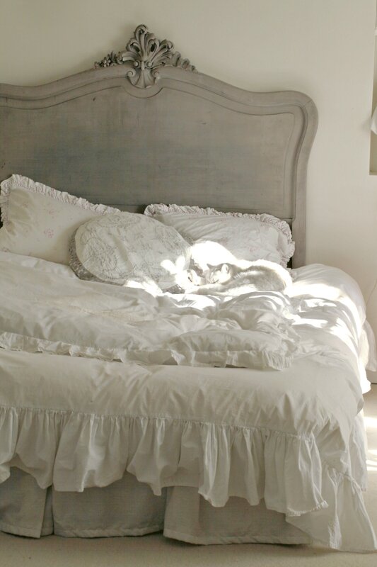 Romantic bedroom decor in this shabby chic bedroom with feminine bedding with ruffles. #bedroomdecor #whitebedroom #shabbychic #romanticdecor