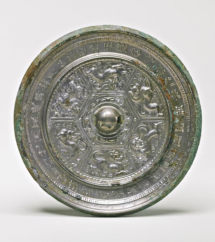 A bronze 'Mythical Beasts' mirror with inscription, Sui dynasty