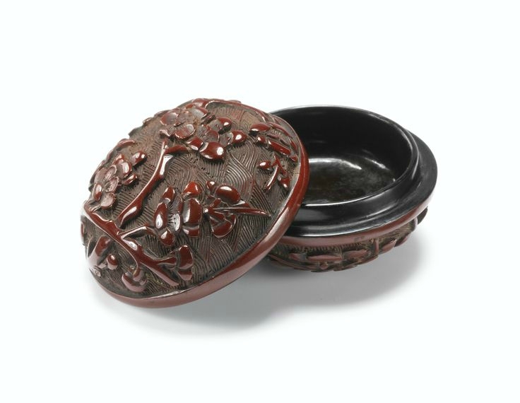 A carved cinnabar lacquer 'Prunus' box and cover, Ming dynasty, 15th-16th century