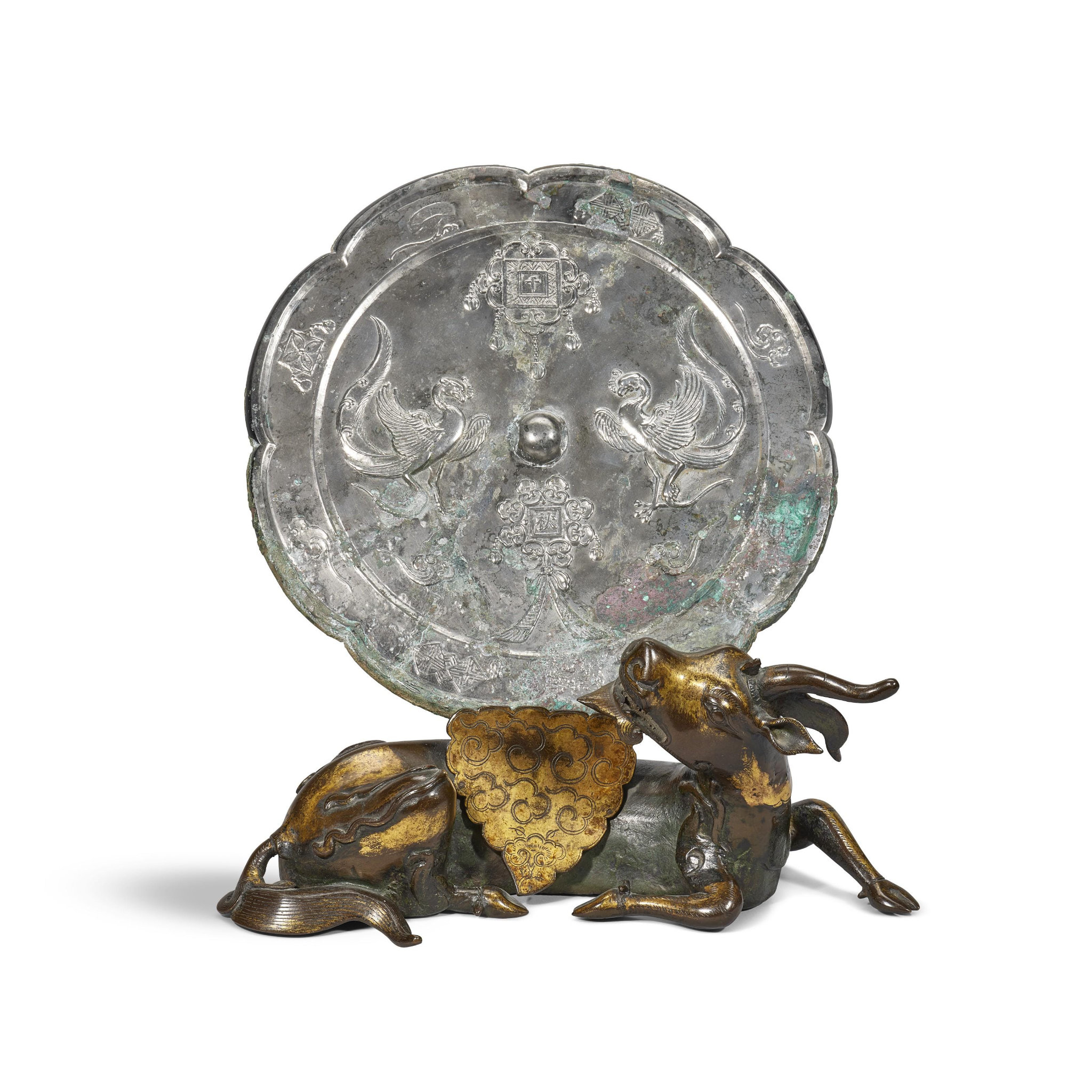 Liao dynasty (907-1125) bronze mirror and a parcel-gilt bronze mythical beast-form mirror stand, Yuan-Ming Dynasty (1279-1644)
