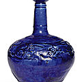 A moulded cobalt-blue glazed pottery bottle, probably kashan, iran, 12th century
