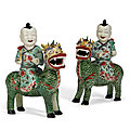 A pair of chinese export porcelain famille verte figures of boys riding qilin, kangxi period (1662-1722)