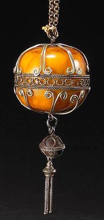 A_carved_amber_specimen_mounted_as_a_necklace