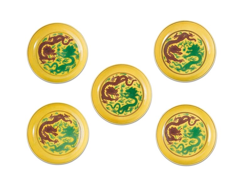 Five yellow-ground green and aubergine-enamel 'dragon' dishes, Qianlong seal marks and period
