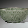 A rare carved longquan celadon deep bowl, ming dynasty, early 15th century